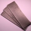 A stack of Nitinol knife blanks